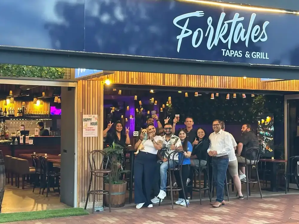 Guests standing outside the Forktales shopfront in the evening