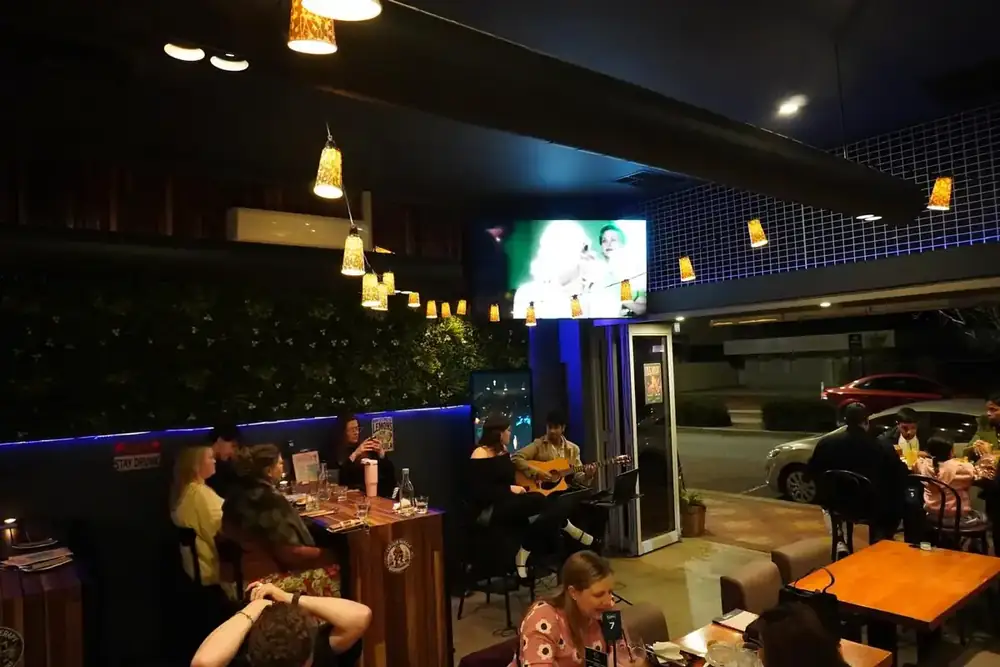 The dining room at night, full of guests