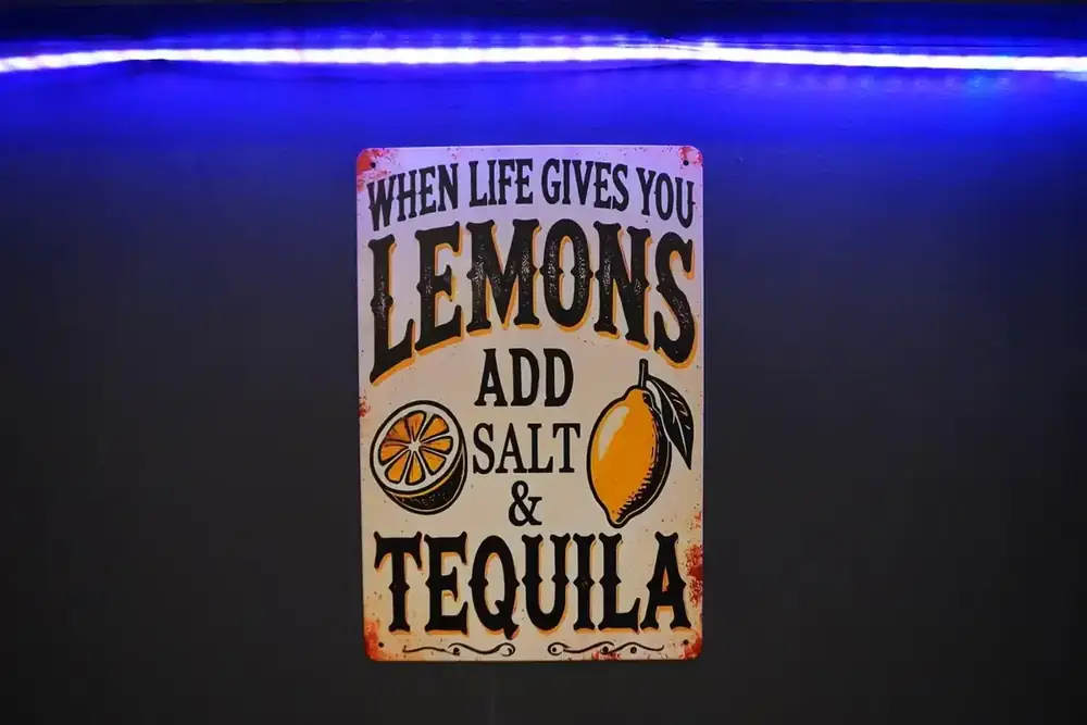 A sign on the wall reading When life gives you lemons add salt and tequila