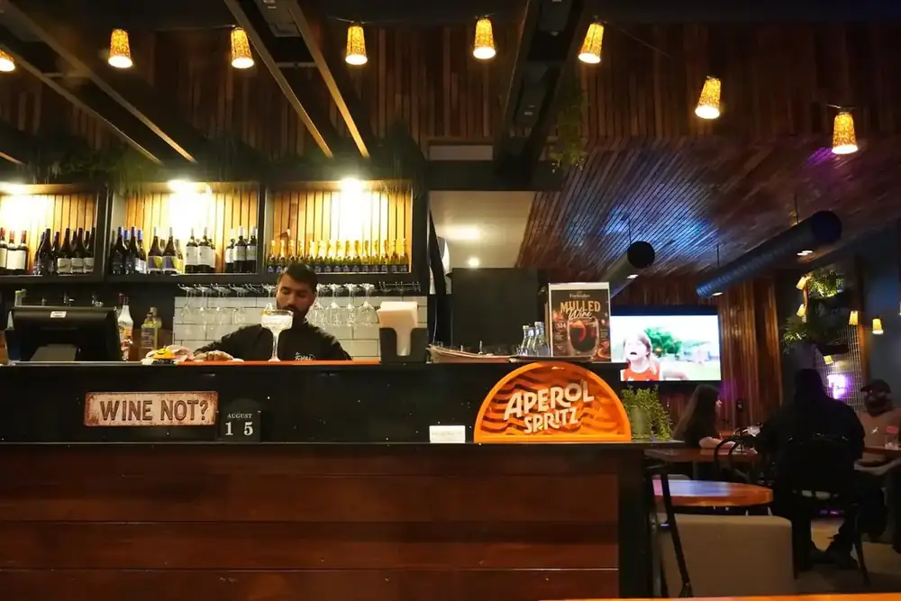 A bartender working behind the Forktales bar