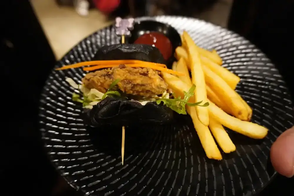 A burger with chips on a patterned plate