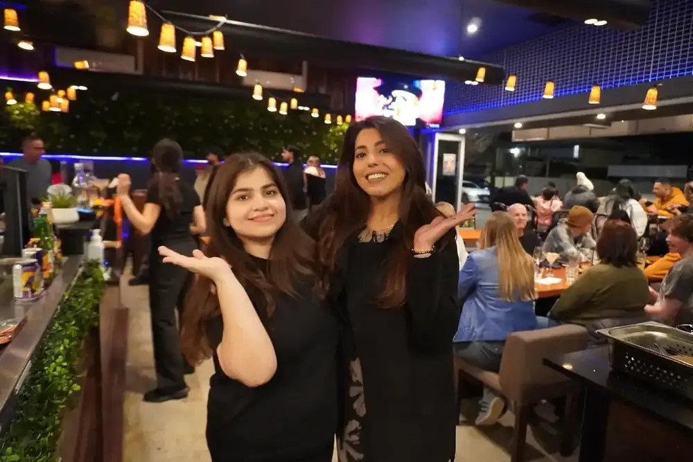 Two guests posing in the dining room