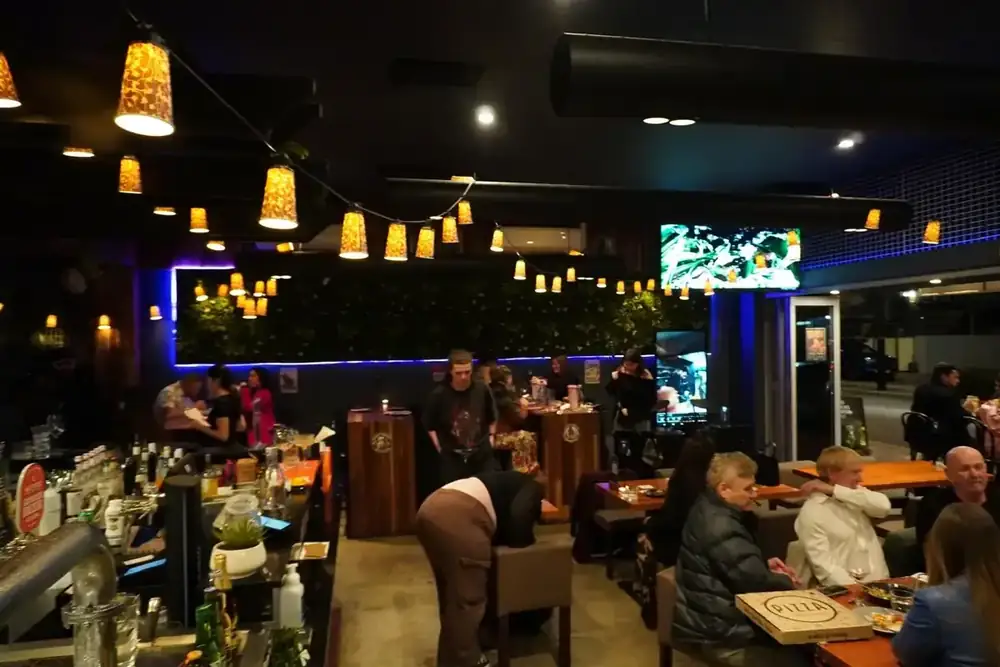 A wide view of the bar and the tables at Forktales