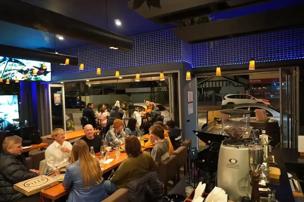 Guests at long tables in the dining room