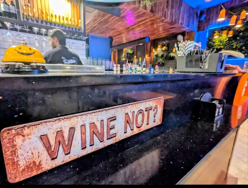 A Wine Not sign on the bar